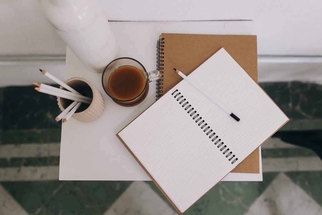 Top View of Coffee, Pencils, and Notebooks